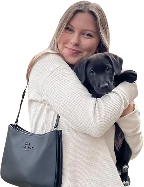 Smiling woman holding dog